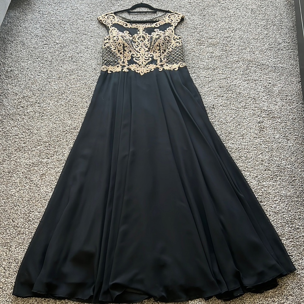 Beautiful gown with gold embroidered iridescent crystal top.
